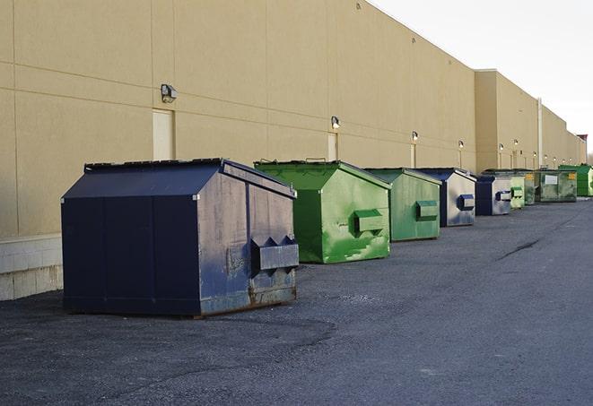 construction dumpsters on a worksite surrounded by caution tape in Hastings